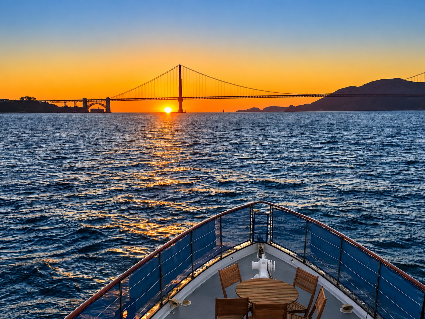 Sunset at the Golden Gate Bridge from the bow of a yacht