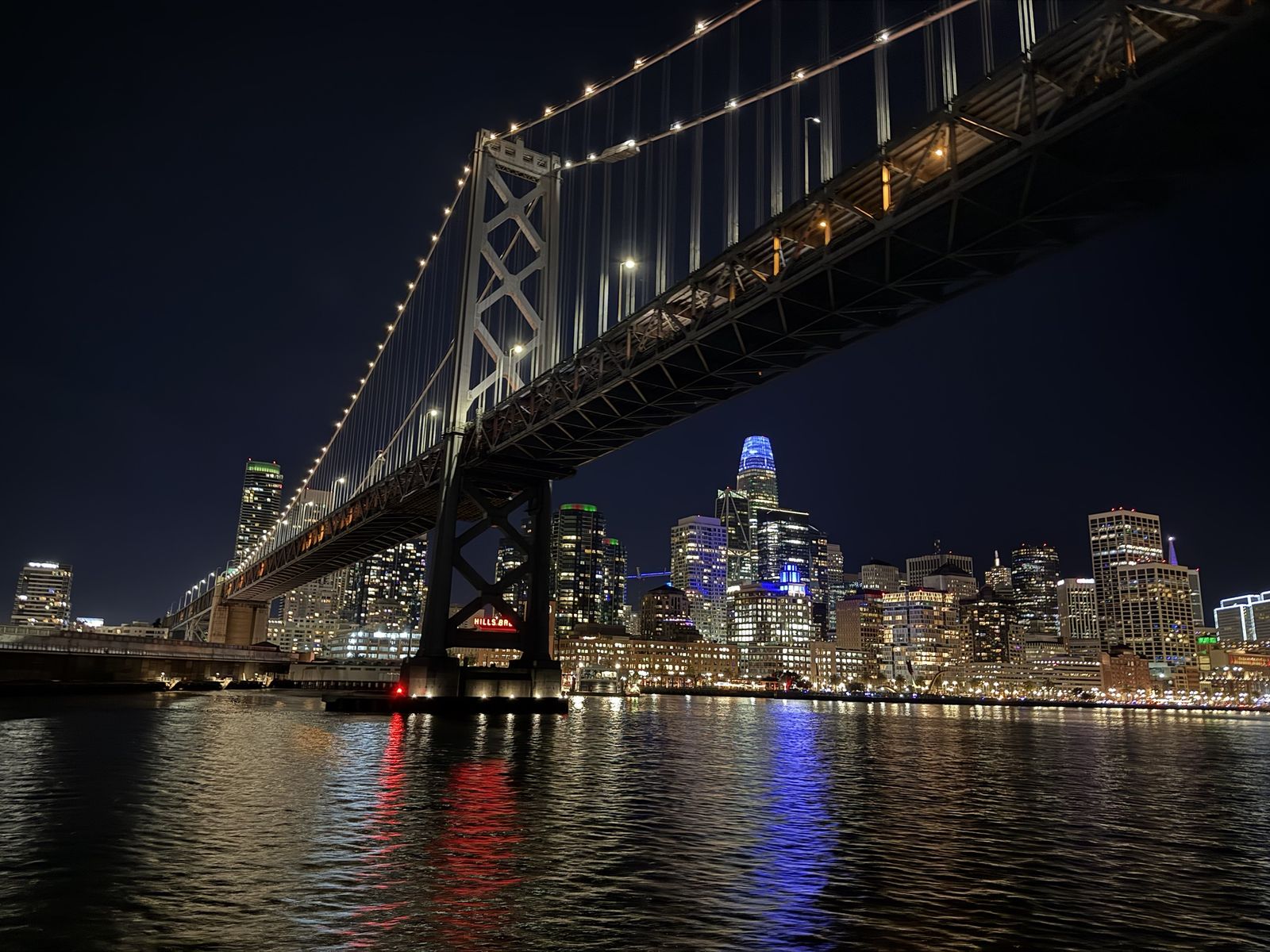 The Bay Bridge and San Francisco skyline at night from the water