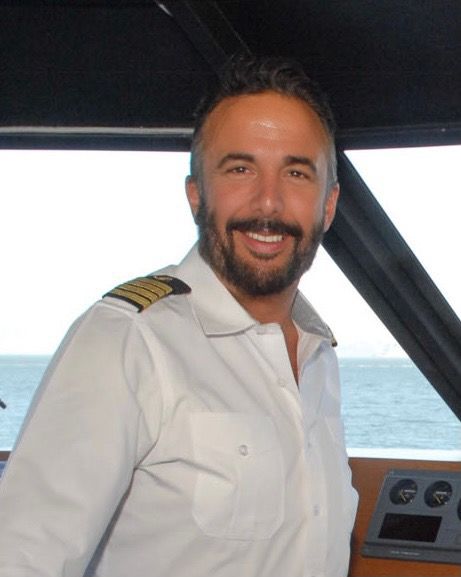 Captain Arlan Stagg in uniform in the wheelhouse