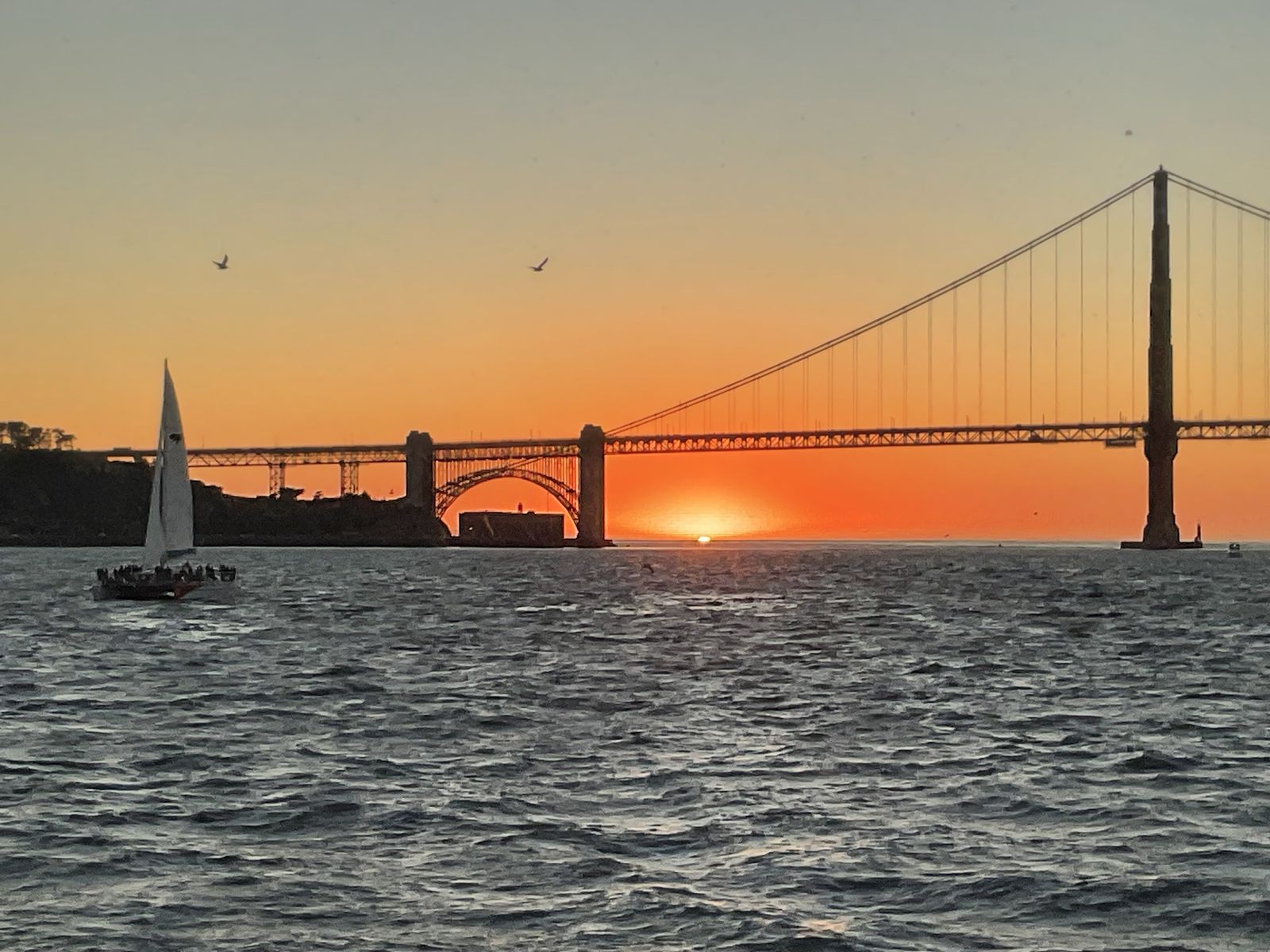 Sunset over the Golden Gate Bridge from a boat on San Francisco Bay
